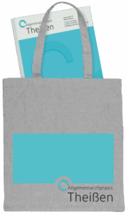 A grey linen branded tote bag containing a branded note pad.